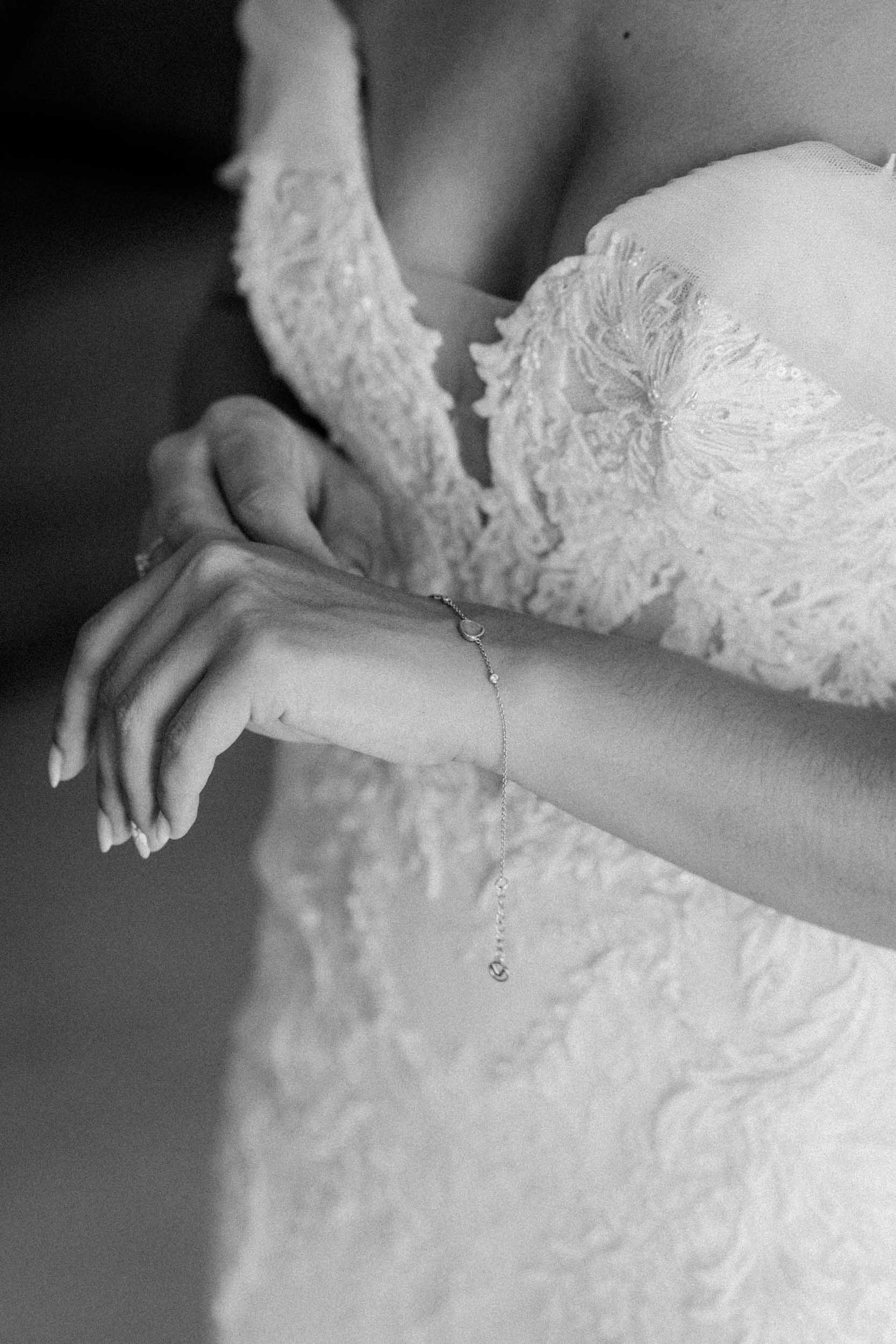 Fine art bridal lace dress and bracelet close-up by Estudio Zoe