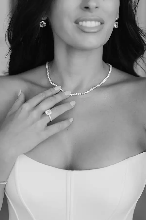 Black-and-white close-up of a bride wearing Swarovski jewelry at her Marbella wedding