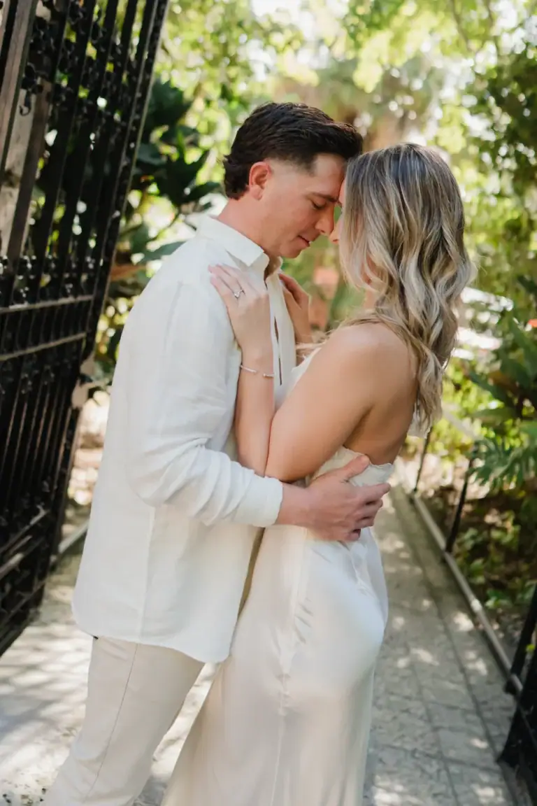 Gabby and Mike embracing in the gardens during their Vizcaya engagement session in Miami