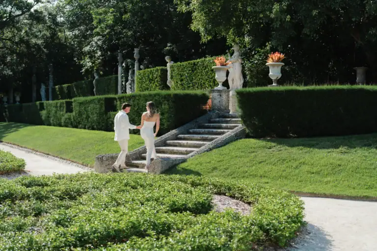 Gabby and Mike walking through the formal gardens at Vizcaya in Miami