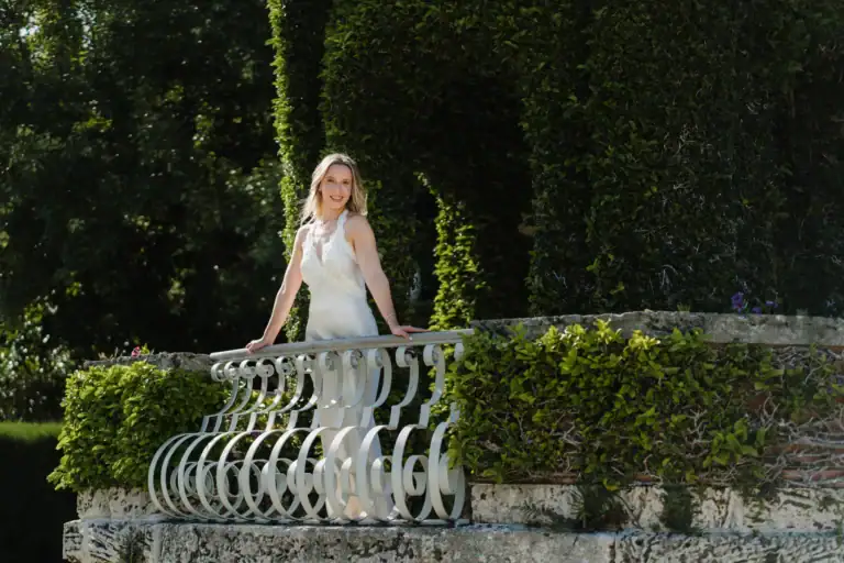 Gabby and Mike sharing a portrait on a garden bridge at Vizcaya