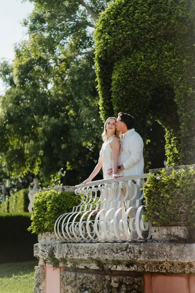 Gabby standing on a stone bridge in the gardens at Vizcaya