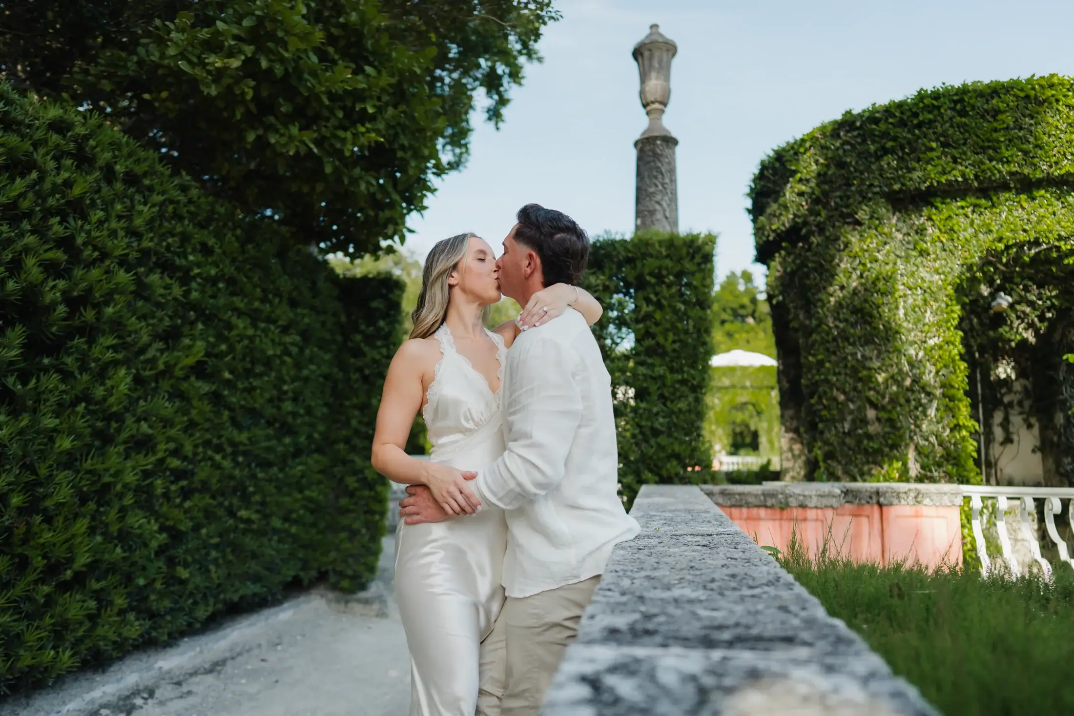 Gabby and Mike walking through the gardens during their Vizcaya engagement session in Miami