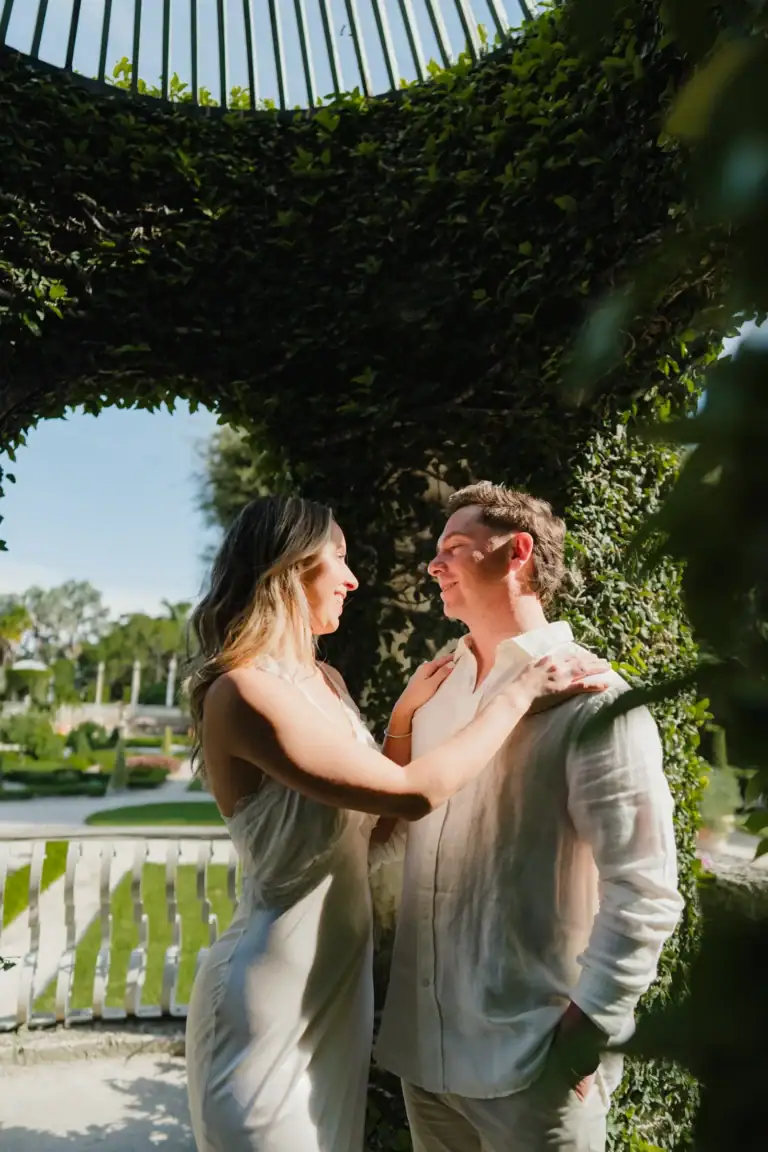 Gabby and Mike embracing in the gardens during their Vizcaya engagement session in Miami