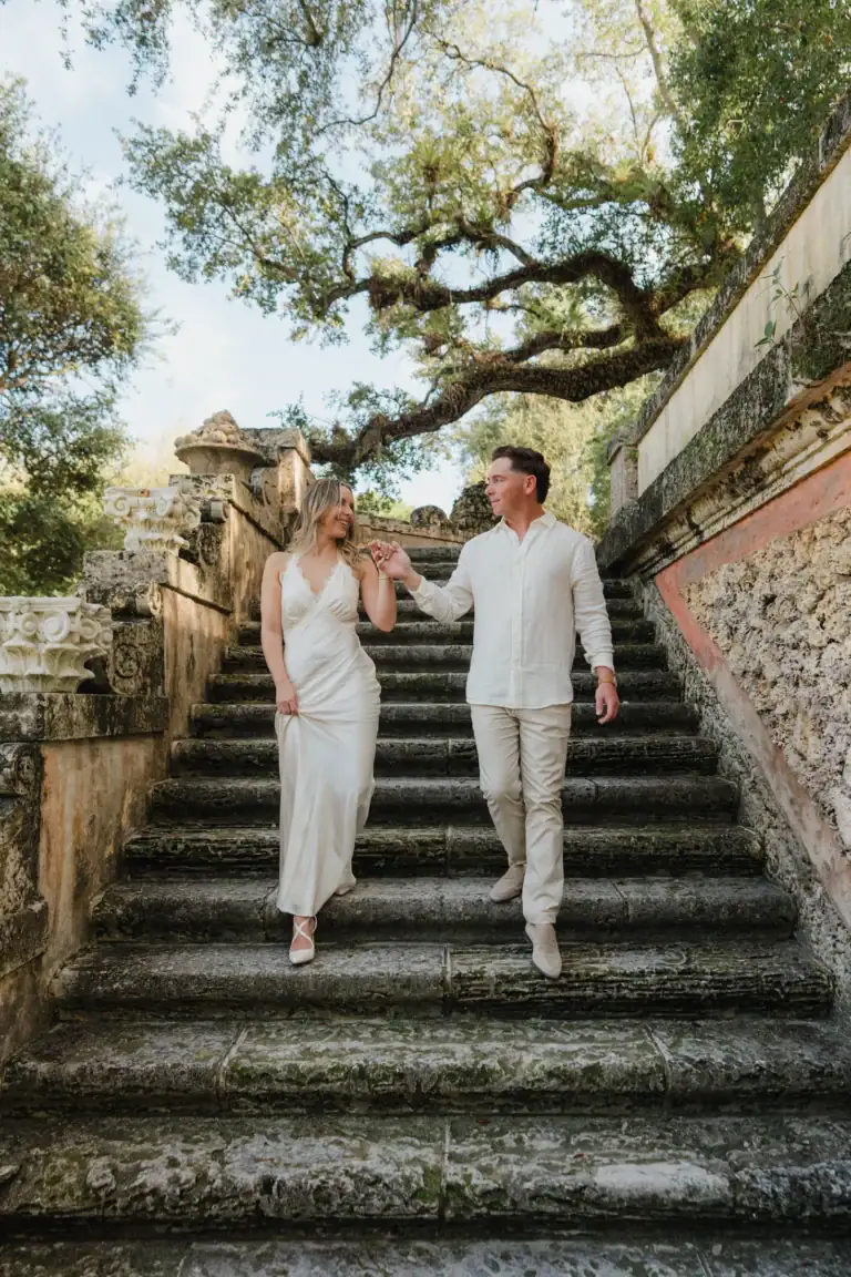 Vertical portrait of Gabby and Mike on a staircase at Vizcaya