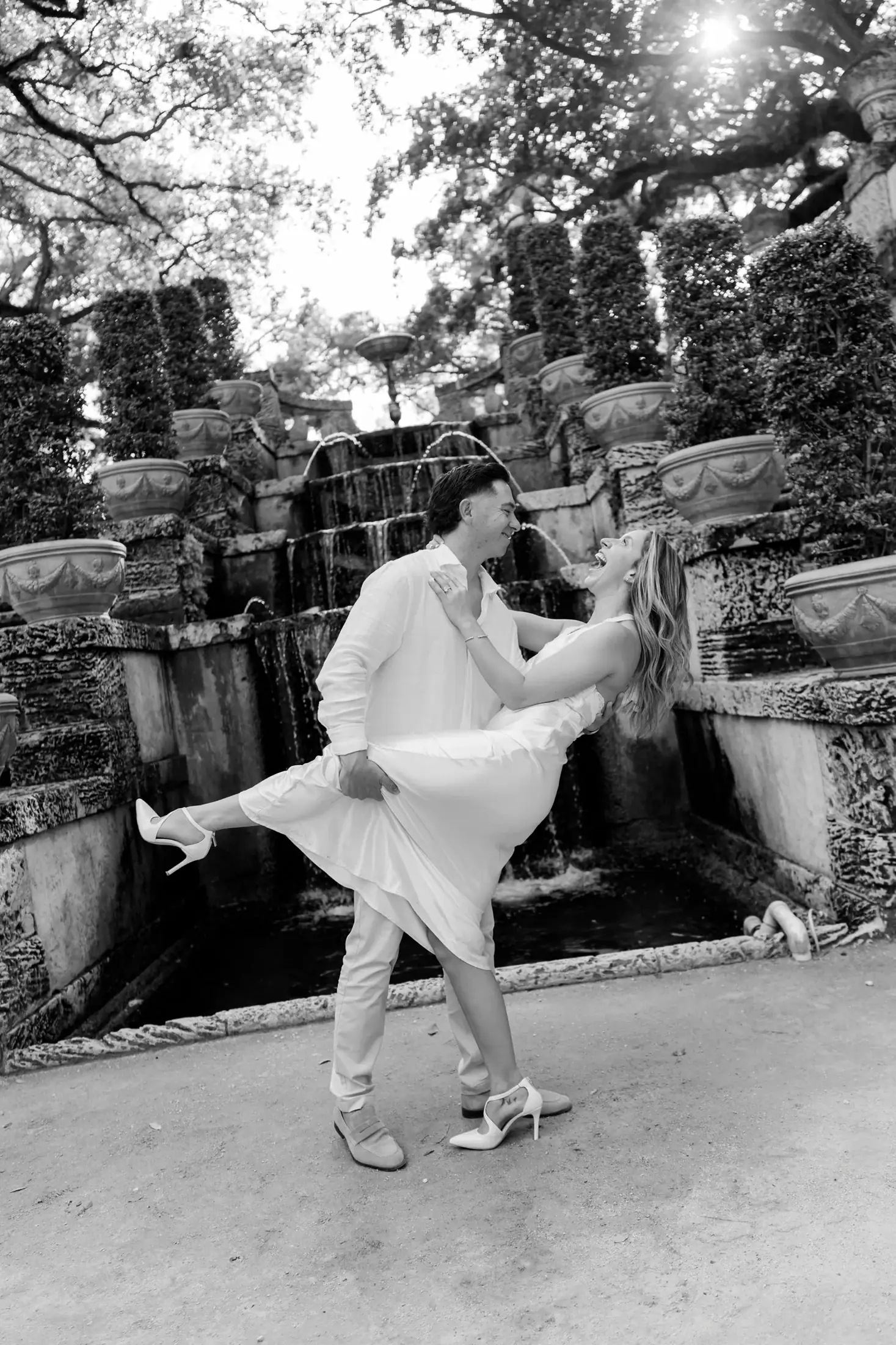 Black and white movement portrait of Gabby and Mike during their Vizcaya engagement session in Miami