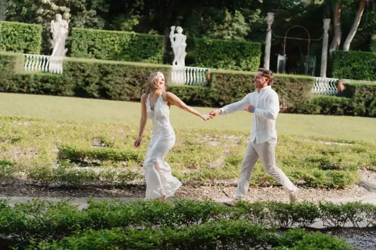 Gabby and Mike walking through the formal gardens during their Vizcaya engagement session