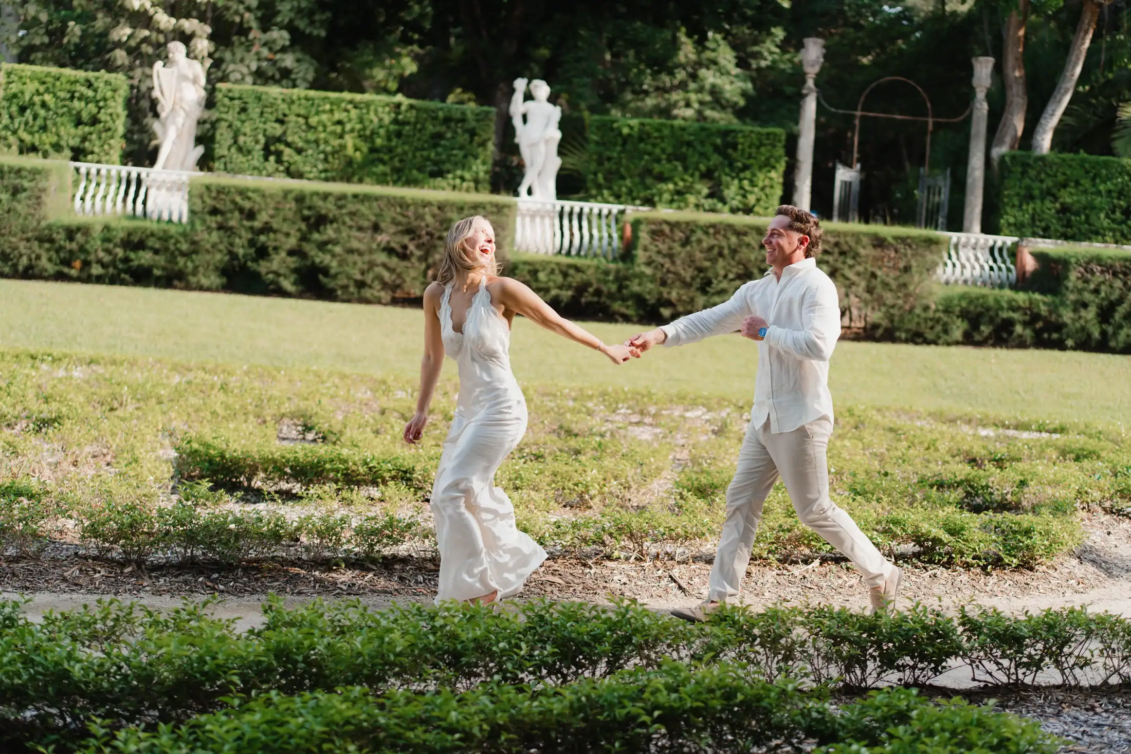 Gabby and Mike walking through the formal gardens at Vizcaya during their Miami engagement session