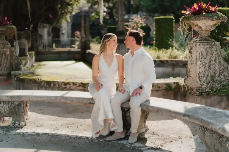 Gabby and Mike near the waterfront gardens during their Vizcaya engagement session in Miami