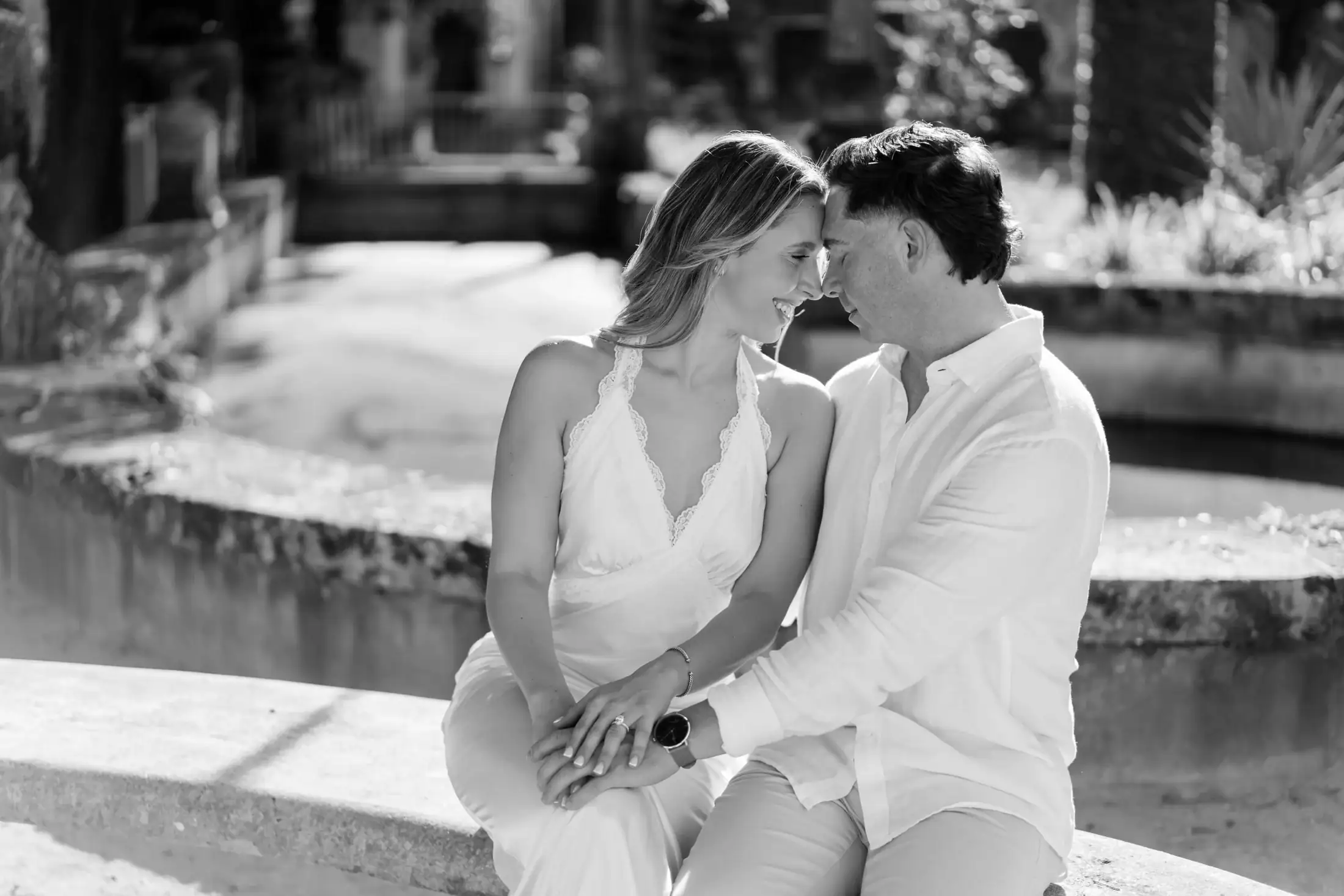 Black and white candid photo of Gabby and Mike during their Vizcaya engagement session