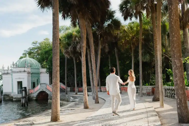 Gabby and Mike walking near Biscayne Bay during their Vizcaya Gardens engagement session in Miami