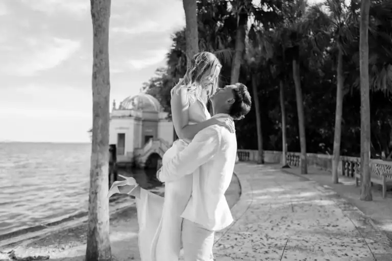 Black and white waterfront portrait of Gabby and Mike at Vizcaya Museum and Gardens