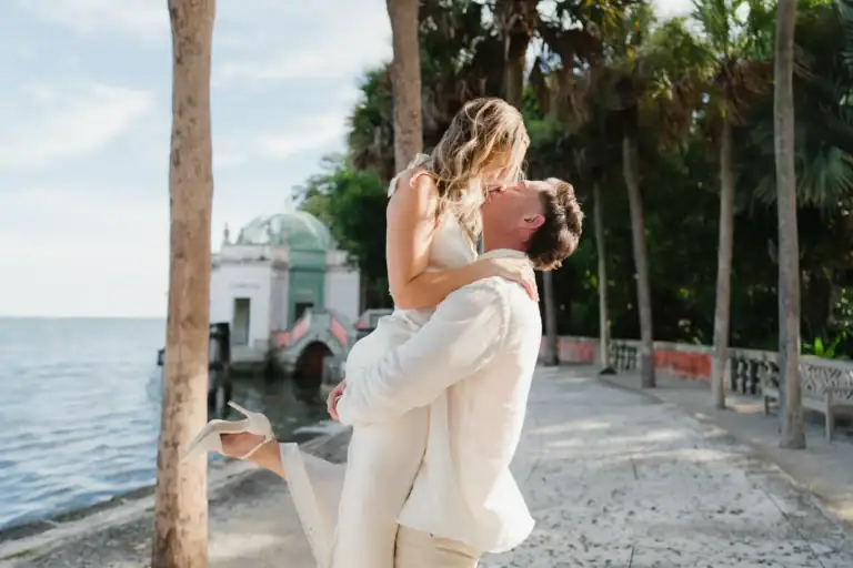 Romantic embrace by the waterfront during Gabby and Mike’s Vizcaya engagement session in Miami