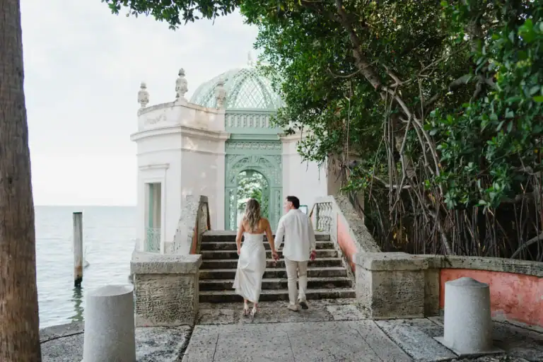 Gabby and Mike photographed near stone architecture by the Vizcaya waterfront
