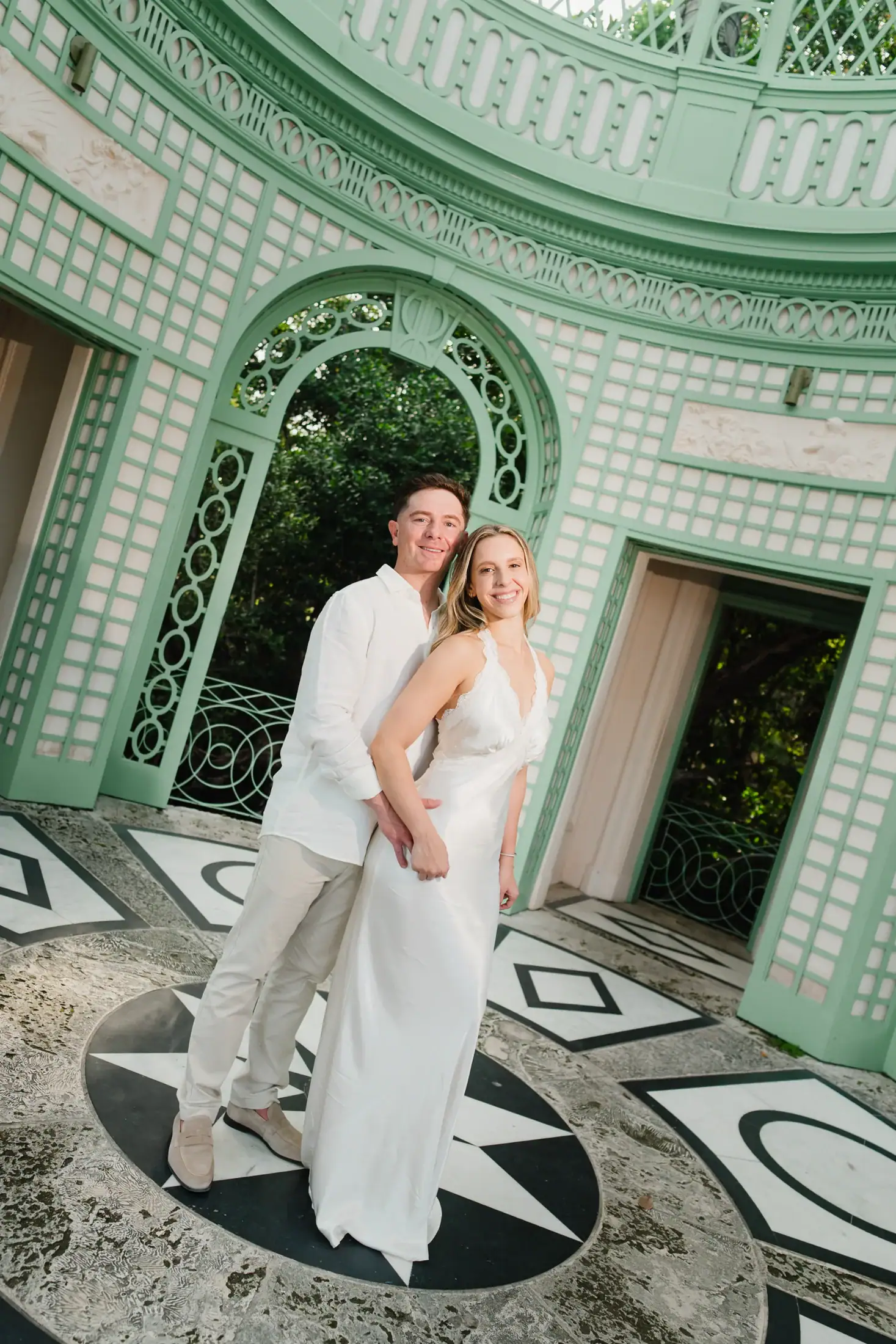 Gabby and Mike framed by an arch inside the Tea House during their Vizcaya engagement photos
